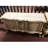 A continental white and gilt two door buffet sideboard width 133 cm
