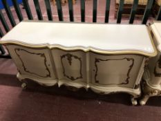 A continental white and gilt two door buffet sideboard width 133 cm