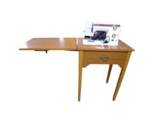 A New Home super automatic sewing machine with foot pedal in table