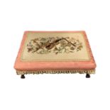 A large upholstered beech footstool, the tapestry top depicting a violin and sheet music,