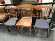 A pair of 19th century mahogany and beech rail backed chairs together with a further dining chair