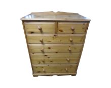 A contemporary pine six drawer chest,