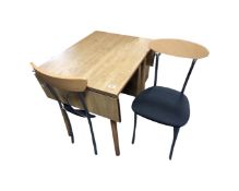 A drop leaf kitchen table together with a pair of Effezeta dining chairs on tubular metal legs.