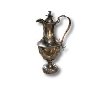 A George III silver claret jug, Emick Romer, London 1776, engraved with a crest, height 31cm.