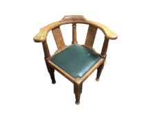 A carved oak corner chair