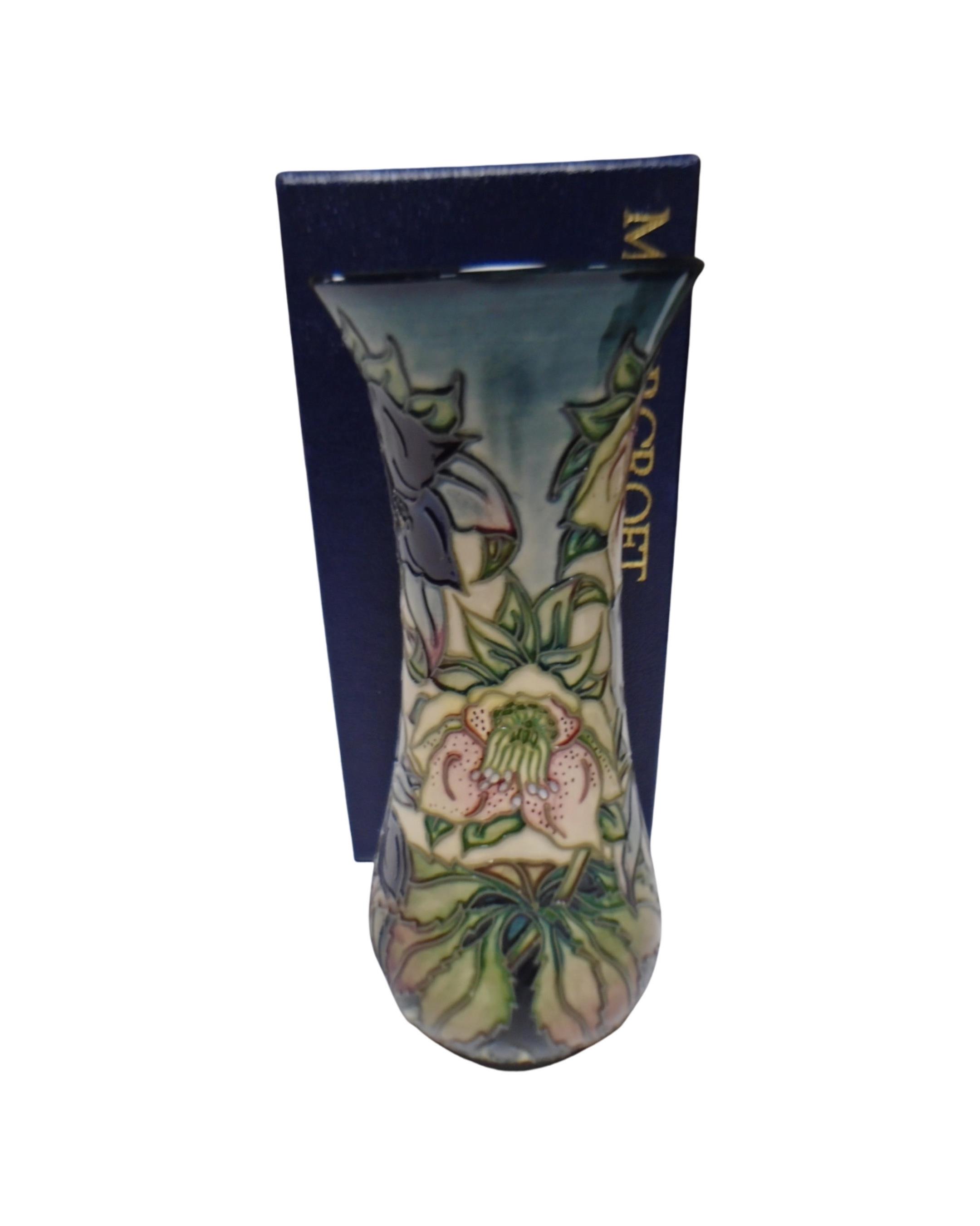 A Moorcroft vase decorated with lilies, boxed.