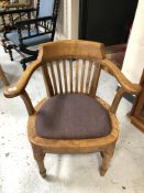 An Edwardian oak smoker's armchair