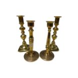 Two pairs of brass candlesticks.