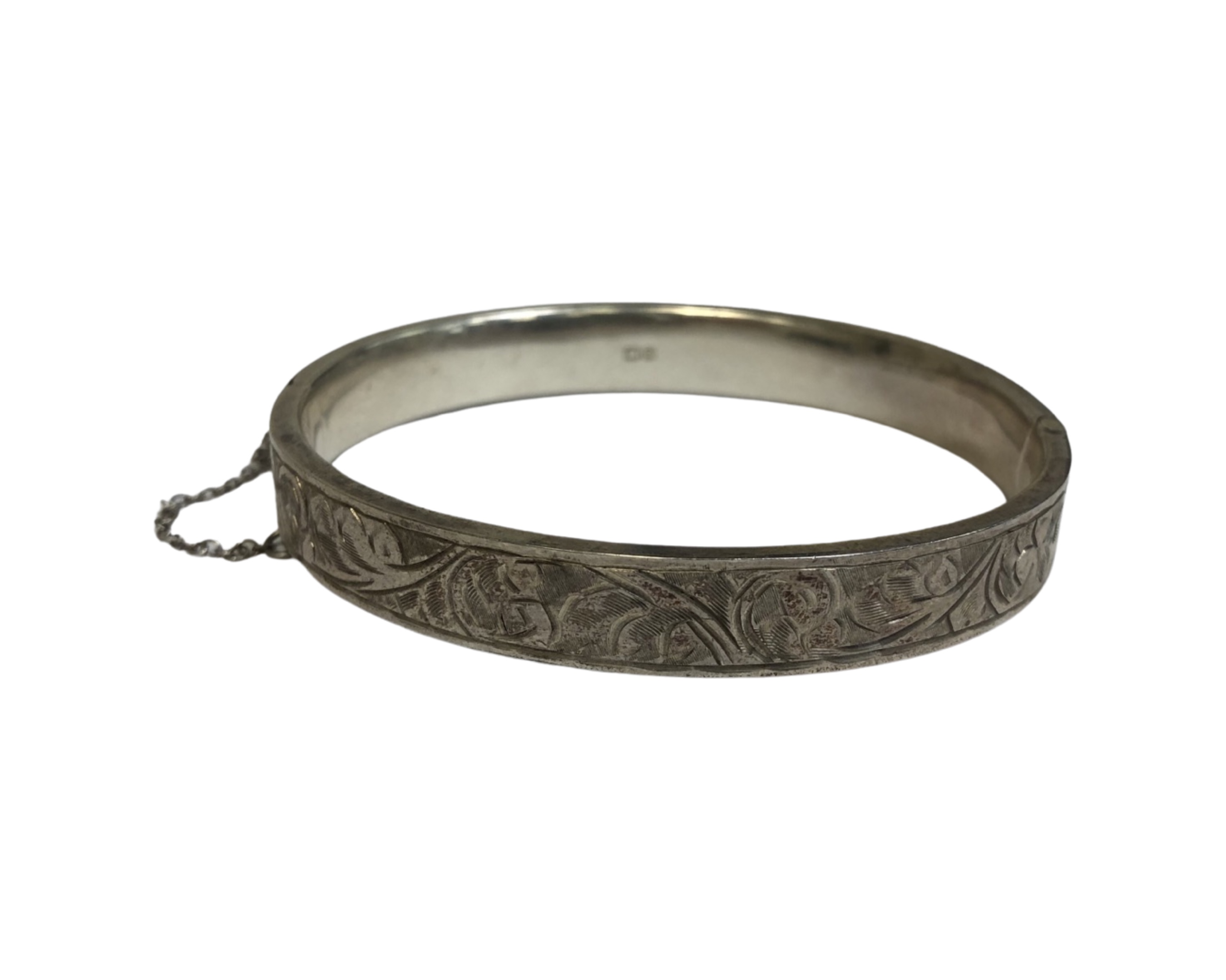 A silver bangle with safety chain, Chester 1952, 12.9g.