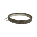 A silver bangle with safety chain, Chester 1952, 12.9g.