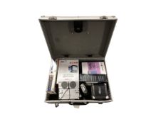 An aluminium case containing Black and Decker cordless screw driver,, mini amp, speaker,
