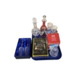 A tray containing assorted glassware including decanters, wine glasses,