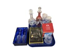 A tray containing assorted glassware including decanters, wine glasses,