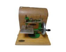 A mid century Grain child's sewing machine in case