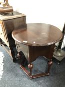 A continental circular topped mahogany cabinet on legs,