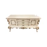 A continental white and gilt two door buffet sideboard fitted with three central drawers width 135
