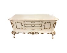 A continental white and gilt two door buffet sideboard fitted with three central drawers width 135