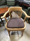 An Edwardian oak smoker's armchair
