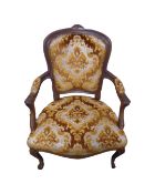 A beech framed French salon armchair in brown and golden fabric