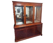 A reproduction yewwood three door display cabinet
