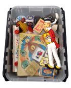 A plastic storage crate containing a quantity of old toys.