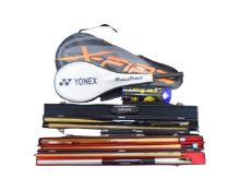 An assortment of sports equipment including a squash racket, a badminton racket,