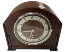 A 1920s oak mantel clock.