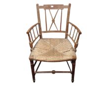 A George III mahogany armchair together with a further spindle backed chair