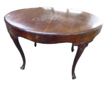 A 19th century mahogany oval dining table on cabriole legs.