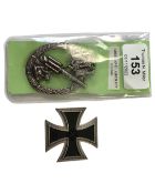 A copy of a German Iron Cross and a similar Anti Aircraft badge.