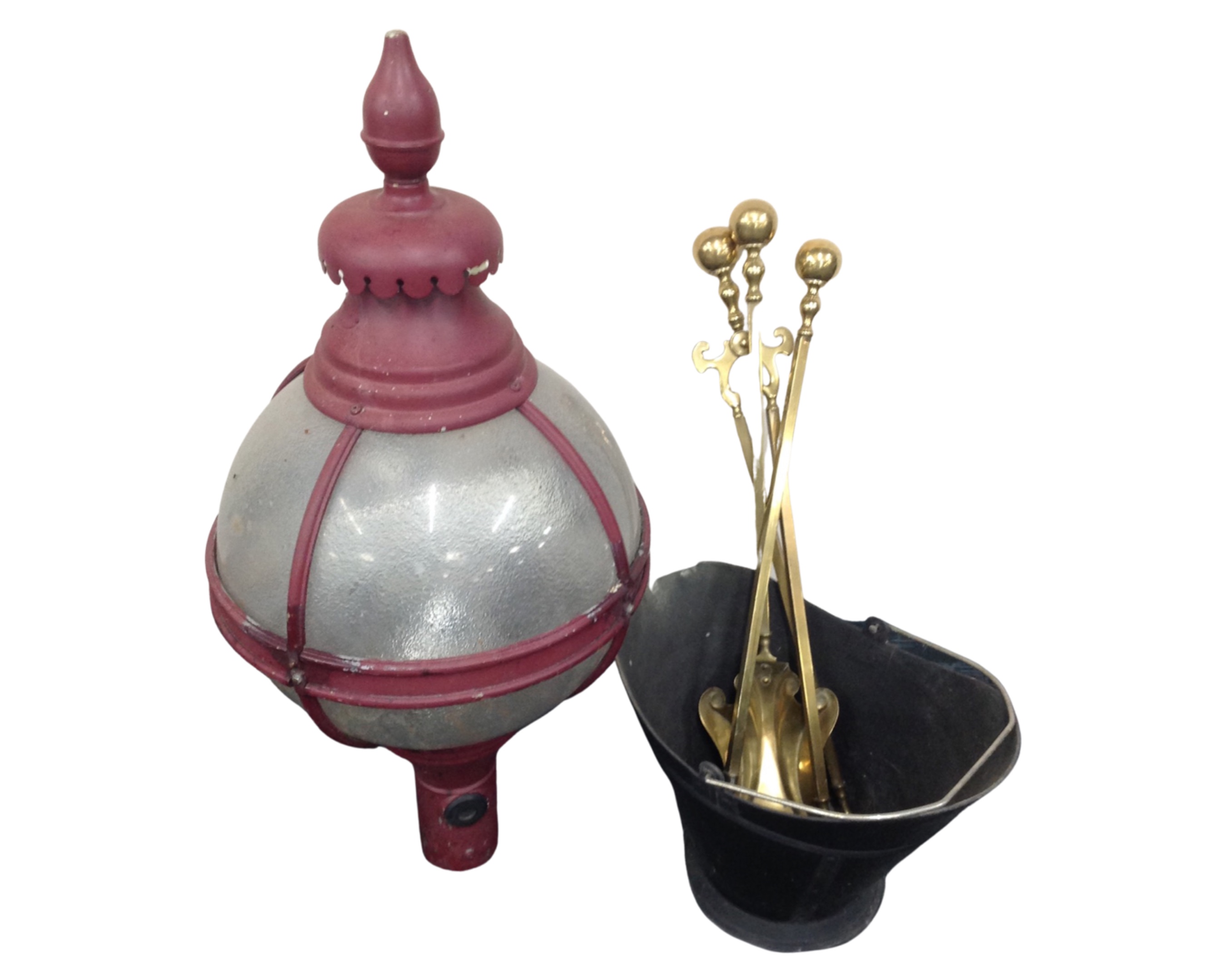 An old metal street lamp together with a bucket containing brass fire companion items.