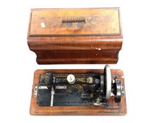 An antique sewing machine in case.