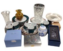 A crate containing glass crystal ornaments, a commemorative plate, green tea and dinnerware,
