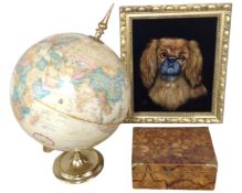 A contemporary portrait on fabric depicting a dog together with a desk globe and a wooden trinket