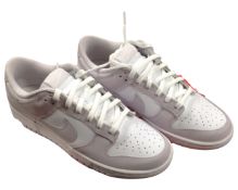 A pair of white Nike lady's trainers.