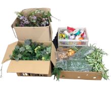 Three boxes containing artificial flowers and a crate of ribbon.