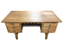 A continental blond oak writing desk fitted with drawers