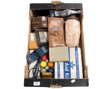 A box containing a salt rock lamp, snakeskin purse, first aid tin etc.