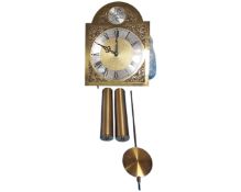 A Tempus Fugit brass dial clock with pendulum and two weights.