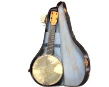 A Burwood acoustic guitar, model JC-36F, in soft carry case, together with a banjo ukulele,
