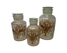 Three antique style glass storage jars with painted decoration.