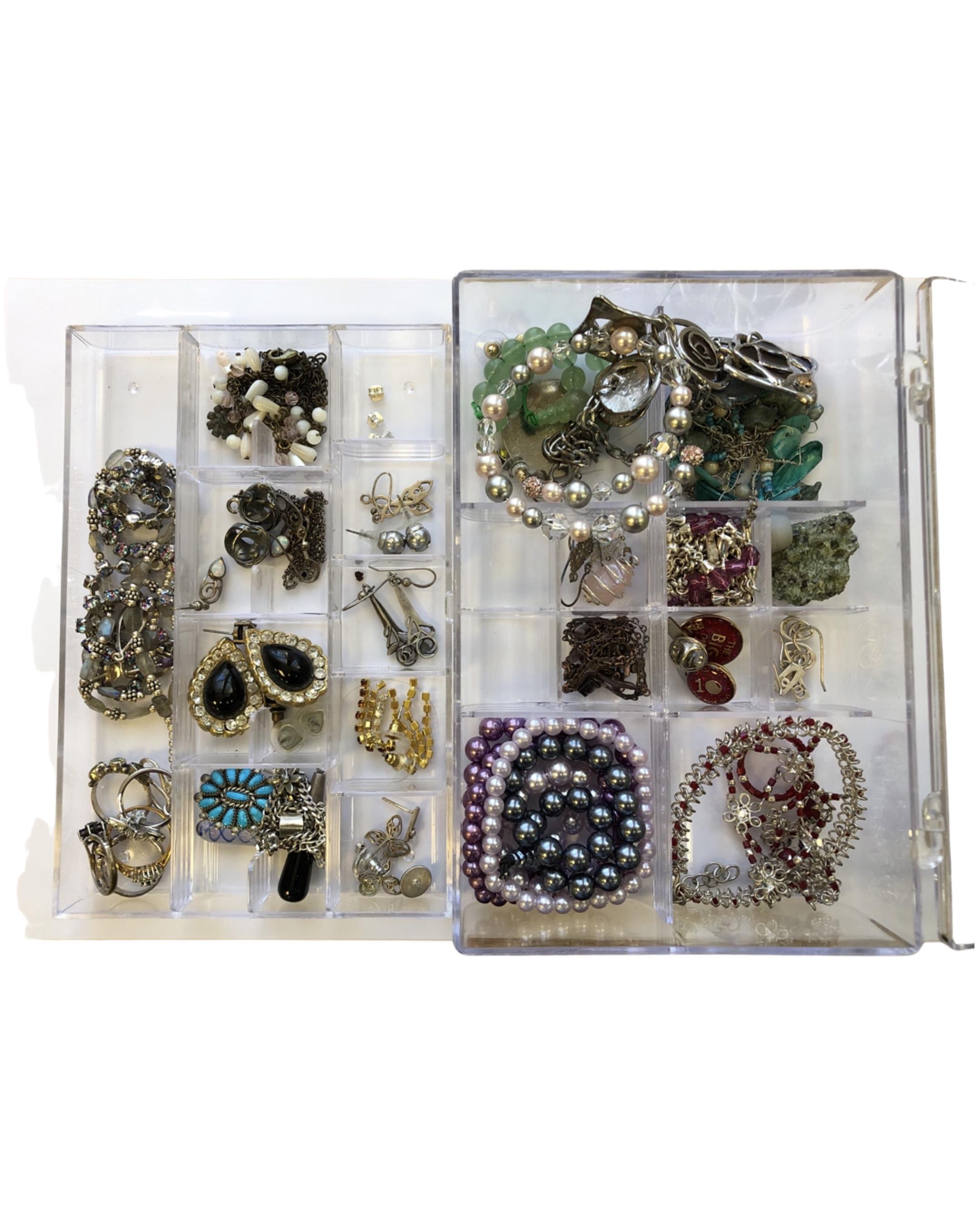 A plastic box of costume jewellery,