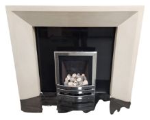 A contemporary fire surround with chrome inset and black slate base
