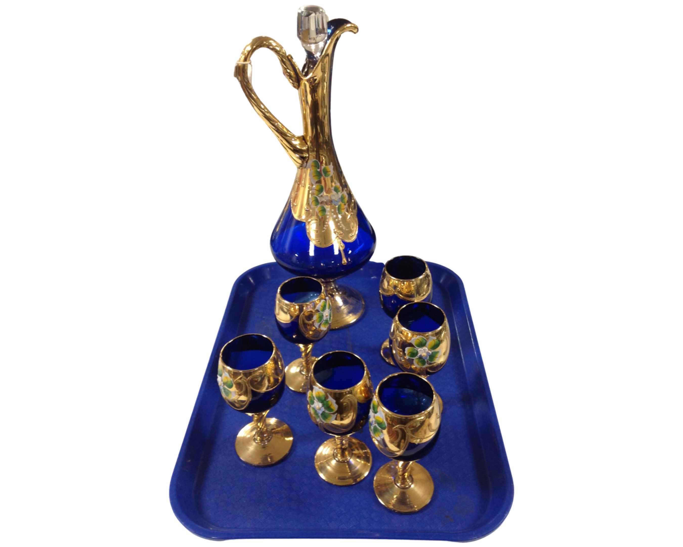 A Murano seven-piece decanter set in deep blue glass, with enamelled floral decoration on gilt,