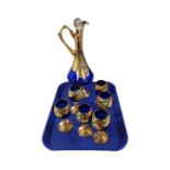 A Murano seven-piece decanter set in deep blue glass, with enamelled floral decoration on gilt,