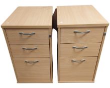 A pair of beech three drawer chests