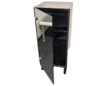 A mirrored bathroom cabinet together with a low stool