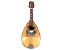 An antique bowl back mandolin with mother of pearl inlay.