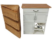 A painted pine storage cabinet together with a wicker corner basket.
