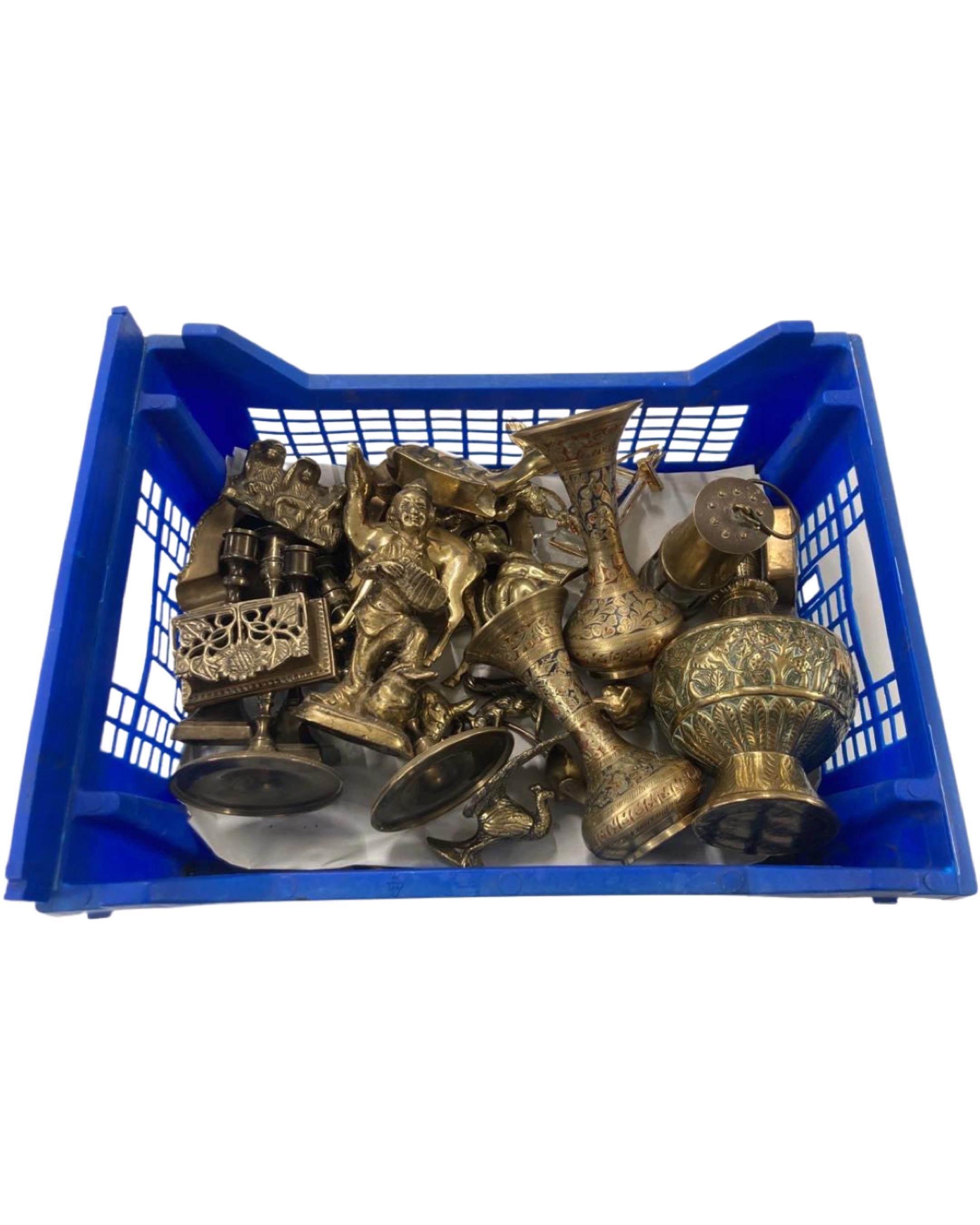 A crate of brass ornaments, a miner's lamp, brass figures, candlesticks etc.